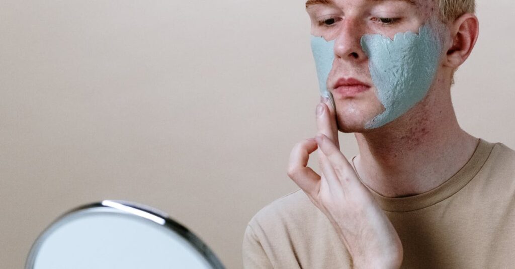 A man giving himself a rejuvenating face mask treatment at home.