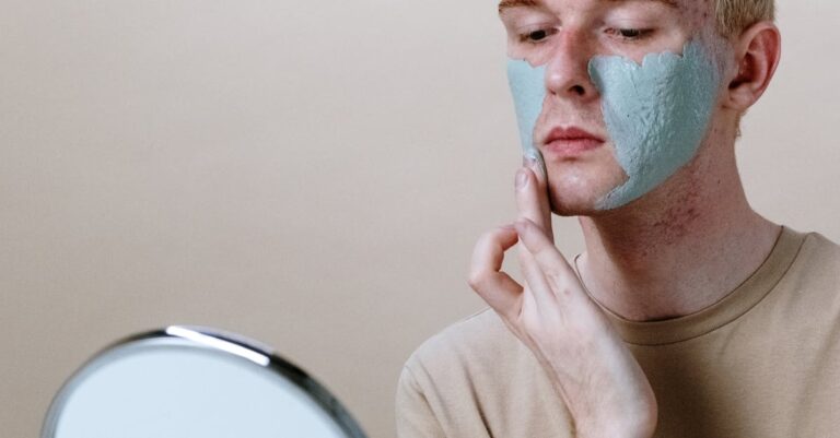 A man giving himself a rejuvenating face mask treatment at home.