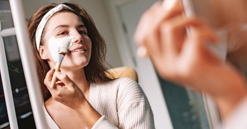 Close-up of a woman applying a face mask for hydration and glowing skin.