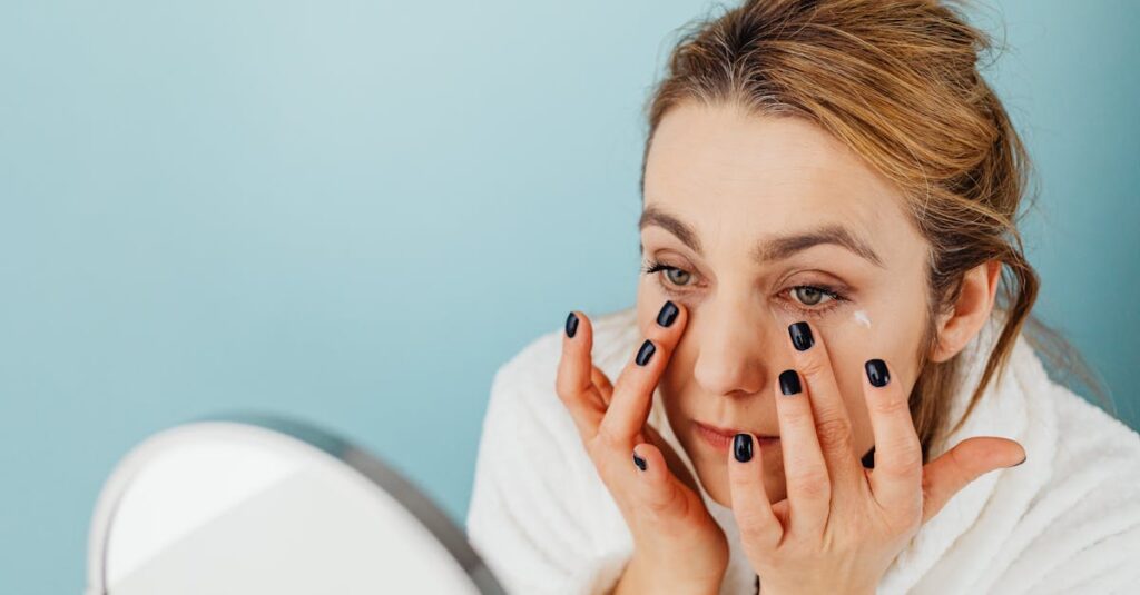 A woman applying eye cream under her eyes while looking into a mirror, addressing under-eye wrinkles.