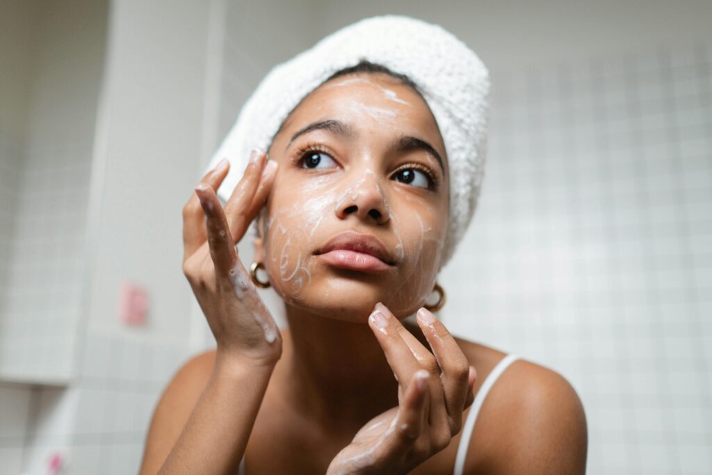 Woman gently cleansing her face with a milky cleanser.