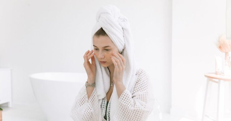 Woman in towel doing skincare routine for oily skin